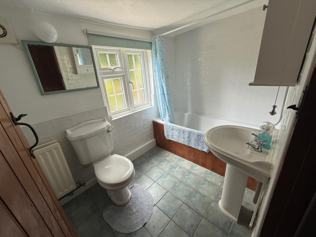 Lot: 150 - PERIOD COTTAGE FOR IMPROVEMENT - Bath with shower over, w/c and wash hand basin